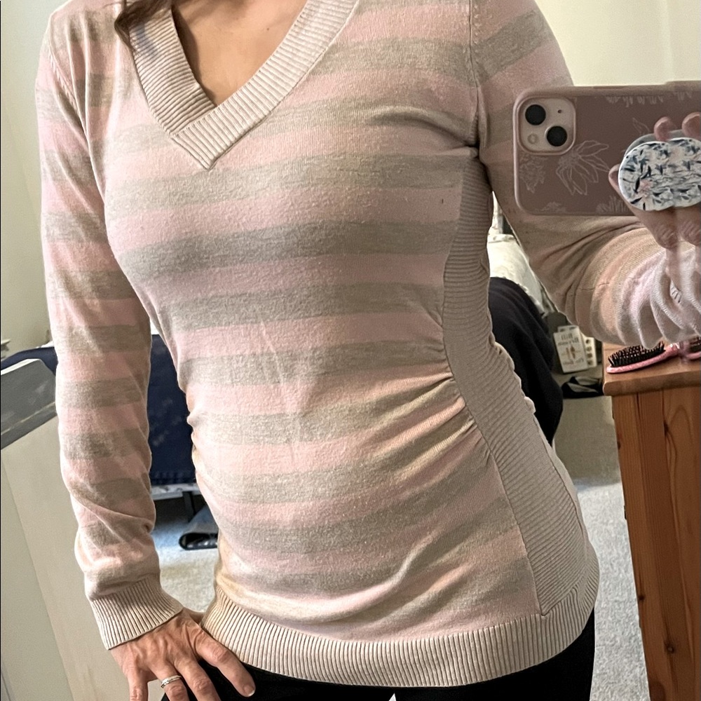 Beautiful delicate slimming striped sweater with side ruching.